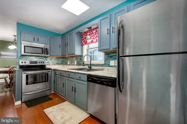 a kitchen with a refrigerator sink and stove