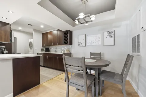 a large kitchen with a table and chairs