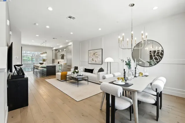 a living room with lots of furniture and chandelier