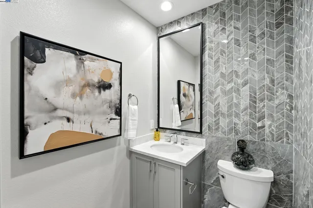 a bathroom with a sink and mirror with toilet