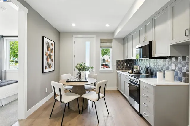 a kitchen with white cabinets and stainless steel appliances