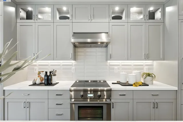 a stove top oven sitting inside of a kitchen