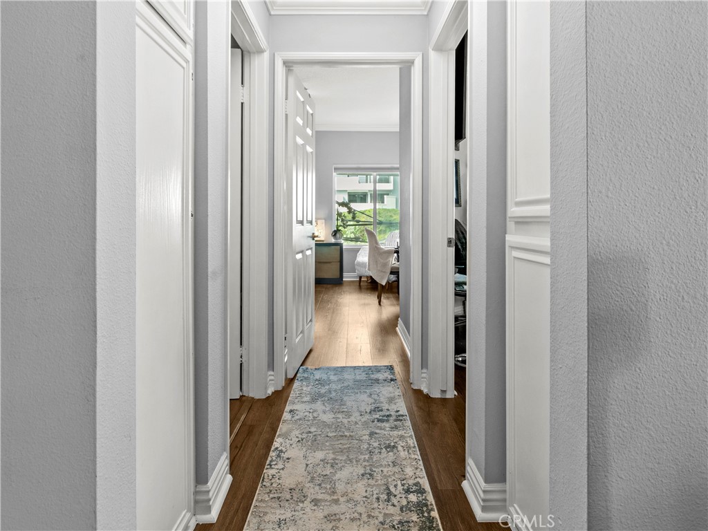 210 Lille Lane, Unit 218 Newport Beach, CA 92663 - Photo 16 of 45 a view of a hallway with white walls
