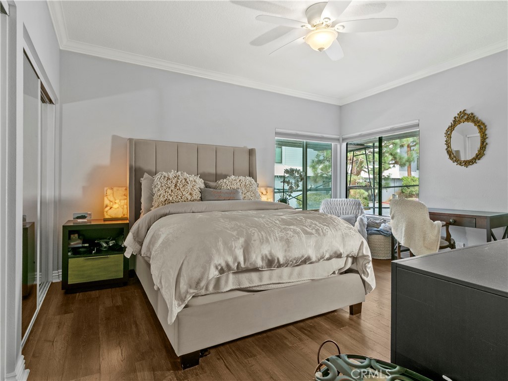 210 Lille Lane, Unit 218 Newport Beach, CA 92663 - Photo 17 of 45 a bedroom with a bed and a chandelier