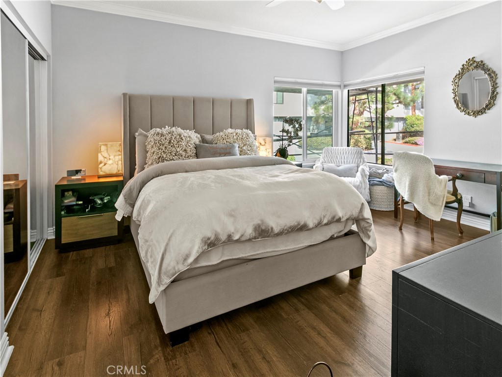 210 Lille Lane, Unit 218 Newport Beach, CA 92663 - Photo 18 of 45 a large bedroom with wooden floor and window