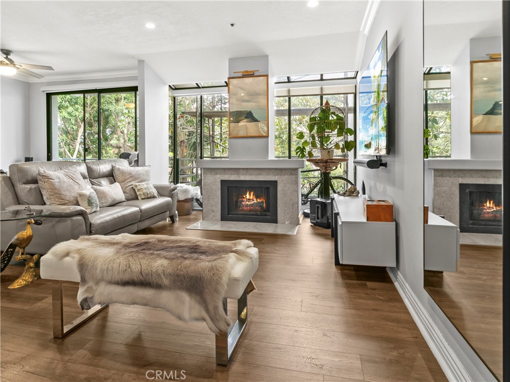 210 Lille Lane, Unit 218 Newport Beach, CA 92663 - Photo 2 of 45 a living room with furniture large window and fireplace