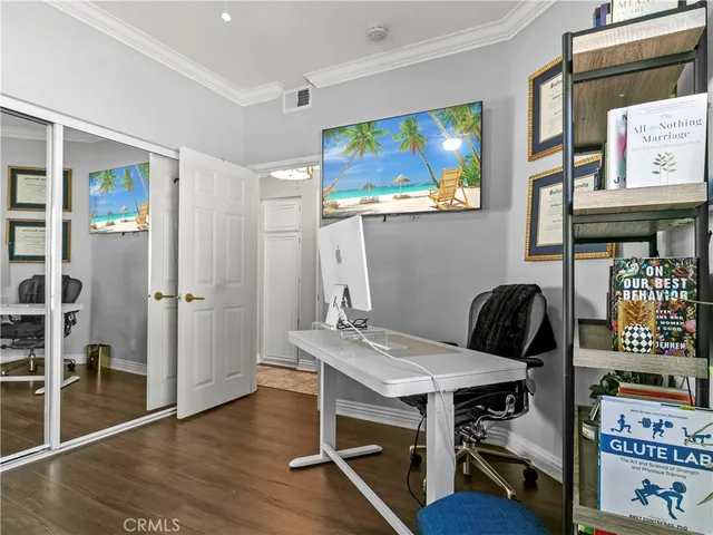 a view of a workspace with furniture and wooden floor