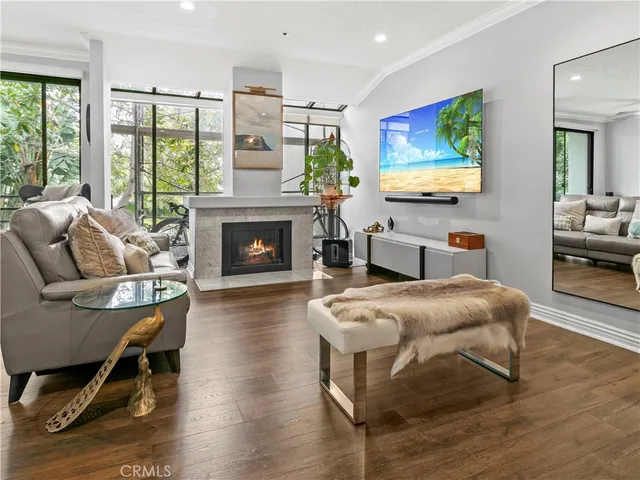 a living room with furniture fireplace and flat screen tv