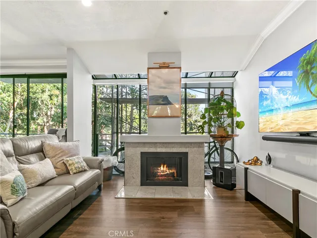 a living room with furniture large window and fireplace