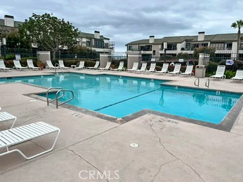 a view of a swimming pool with outdoor seating