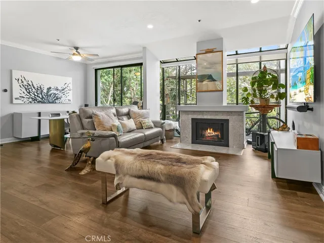 a living room with furniture large window and a fireplace