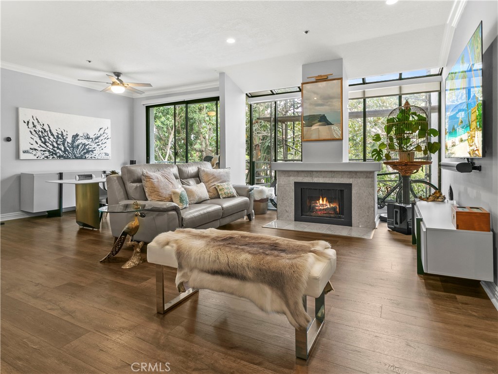 210 Lille Lane, Unit 218 Newport Beach, CA 92663 - Photo 5 of 45 a living room with furniture large window and a fireplace