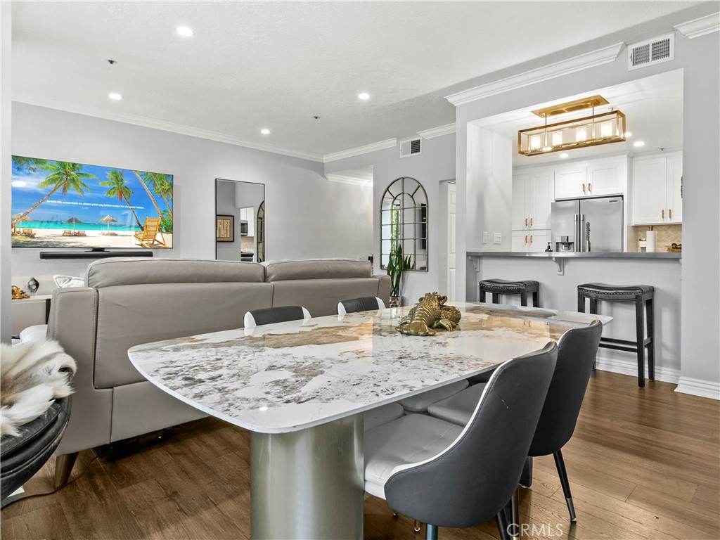 210 Lille Lane, Unit 218 Newport Beach, CA 92663 - Photo 6 of 45 a view of a kitchen area with furniture and wooden floor