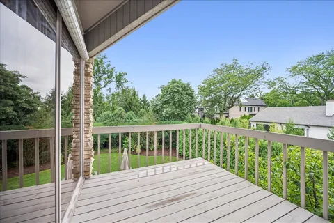 a view of balcony with wooden floor and fence