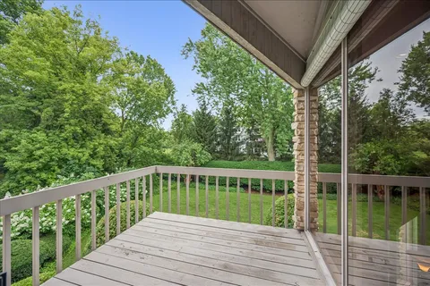 a balcony with wooden floor and fence