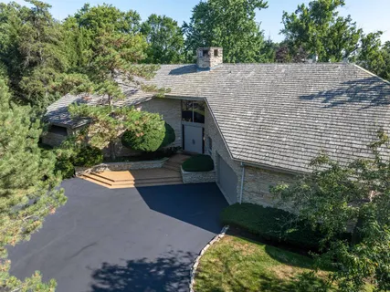 a aerial view of a house with a yard and potted plants
