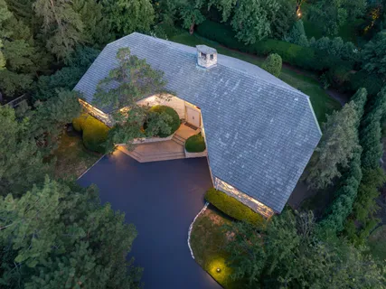 an aerial view of a house with a yard and a swimming pool