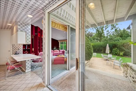 a outdoor space with the couch a chair and potted plant