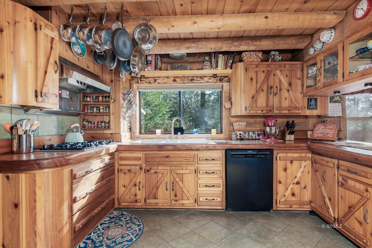 25264 Cougar Road Idyllwild, CA 92549 - Photo 13 of 40 a kitchen with stainless steel appliances granite countertop a stove a sink and a microwave