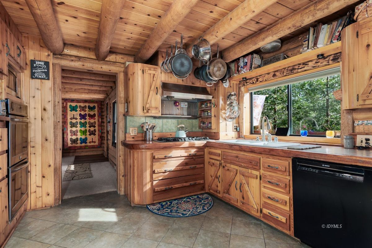 25264 Cougar Road Idyllwild, CA 92549 - Photo 14 of 40 a kitchen that has a lot of cabinets in it