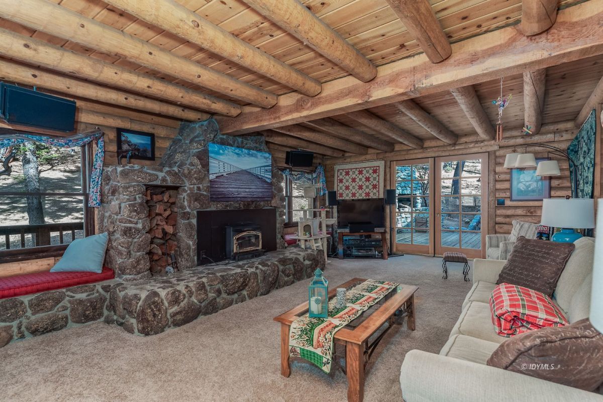25264 Cougar Road Idyllwild, CA 92549 - Photo 20 of 40 a living room with furniture and a fireplace
