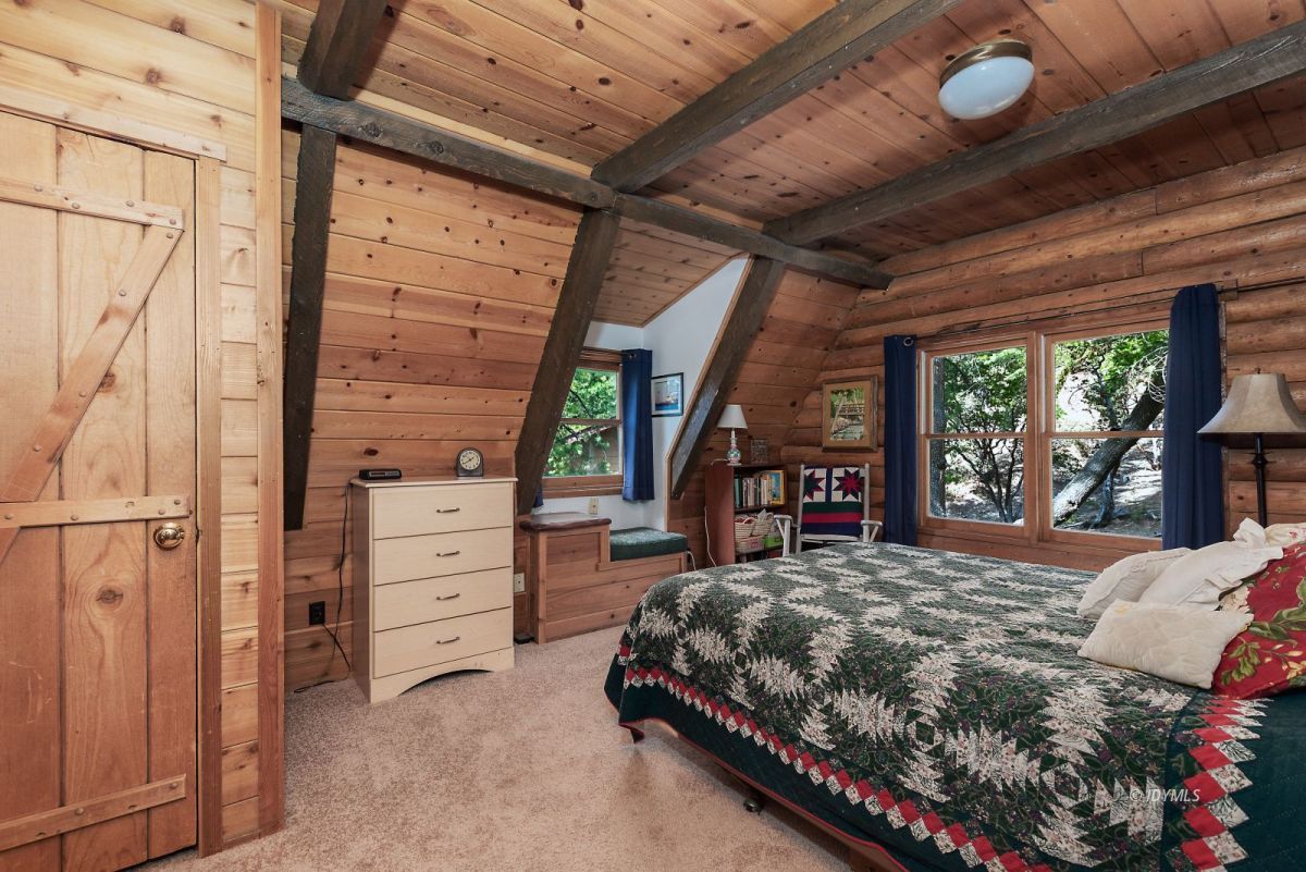 25264 Cougar Road Idyllwild, CA 92549 - Photo 21 of 40 a bedroom with a bed closet and a large window