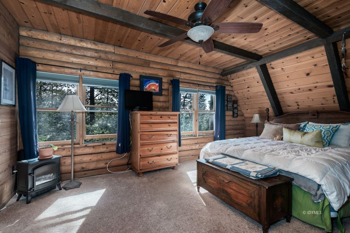 25264 Cougar Road Idyllwild, CA 92549 - Photo 24 of 40 a bedroom with a bed and large windows