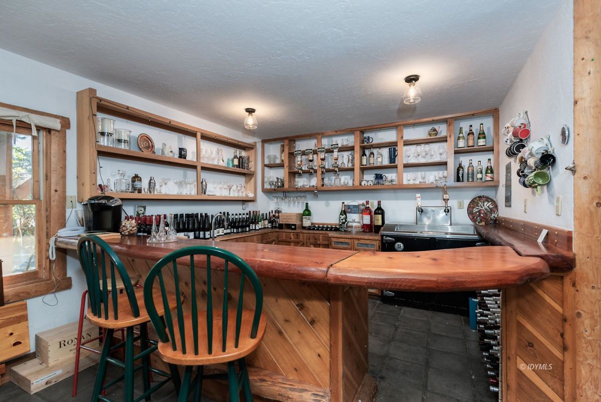 25264 Cougar Road Idyllwild, CA 92549 - Photo 37 of 40 a open kitchen with stainless steel appliances a table chairs and a refrigerator