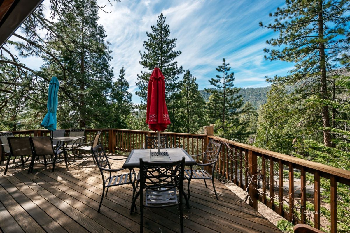 25264 Cougar Road Idyllwild, CA 92549 - Photo 8 of 40 a view of a chairs and table on the deck