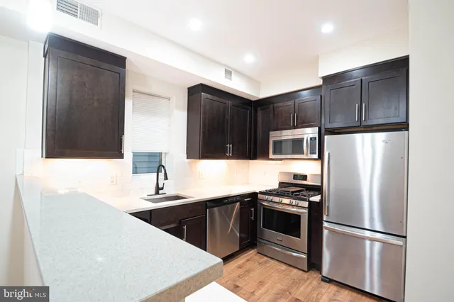 a kitchen with a refrigerator sink and microwave