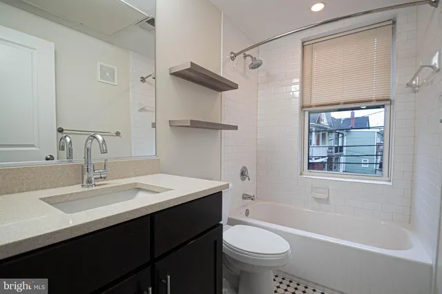 a bathroom with a toilet sink and a mirror