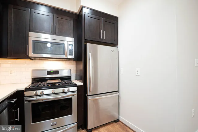 a kitchen with granite countertop cabinets and steel stainless steel appliances