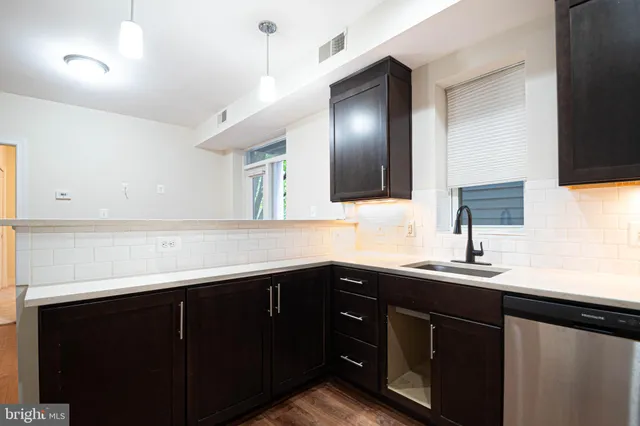 a kitchen with a sink and cabinets