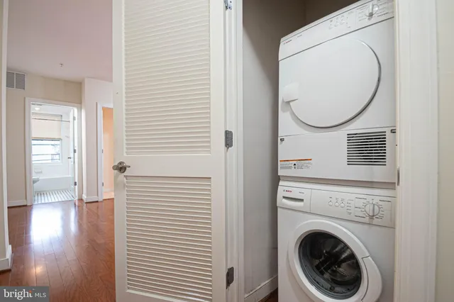 a view of a hallway with washer and dryer