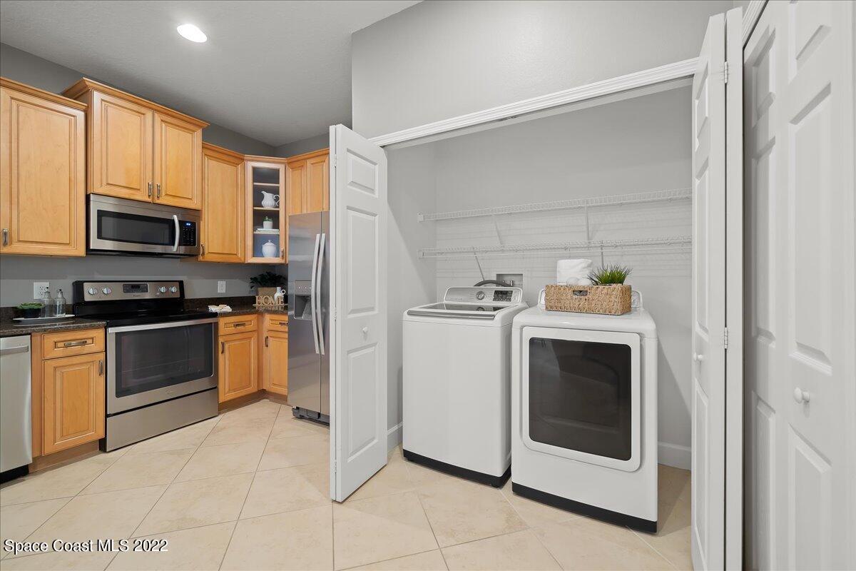 3126 Arden Circle Melbourne, FL 32934 - Photo 12 of 31 a kitchen with a stove top oven and cabinets