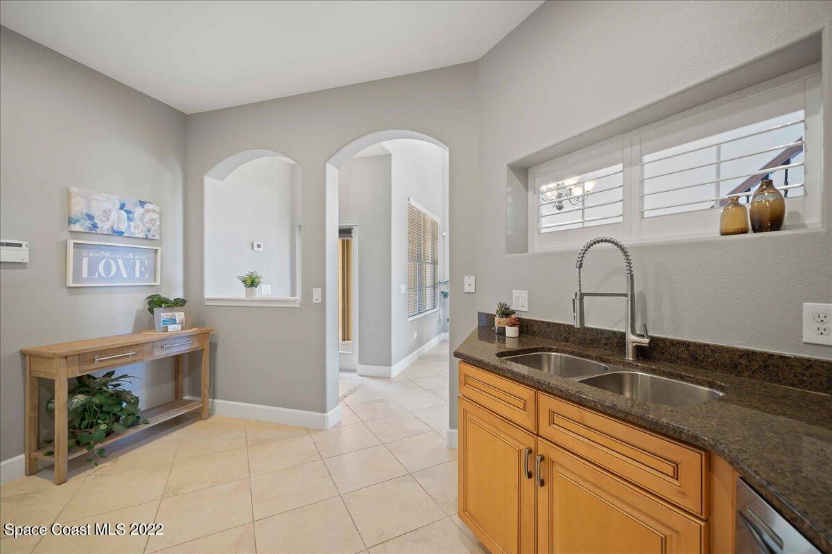 3126 Arden Circle Melbourne, FL 32934 - Photo 13 of 31 a kitchen with granite countertop a sink and cabinets