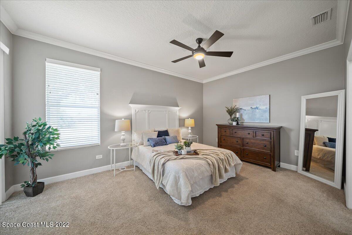 3126 Arden Circle Melbourne, FL 32934 - Photo 14 of 31 a bedroom with a bed and a potted plant