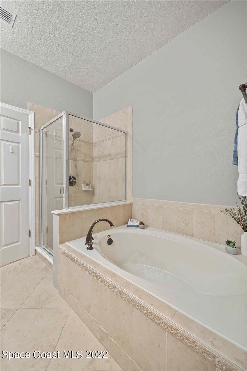 3126 Arden Circle Melbourne, FL 32934 - Photo 19 of 31 a bathroom with a tub a shower and a sink