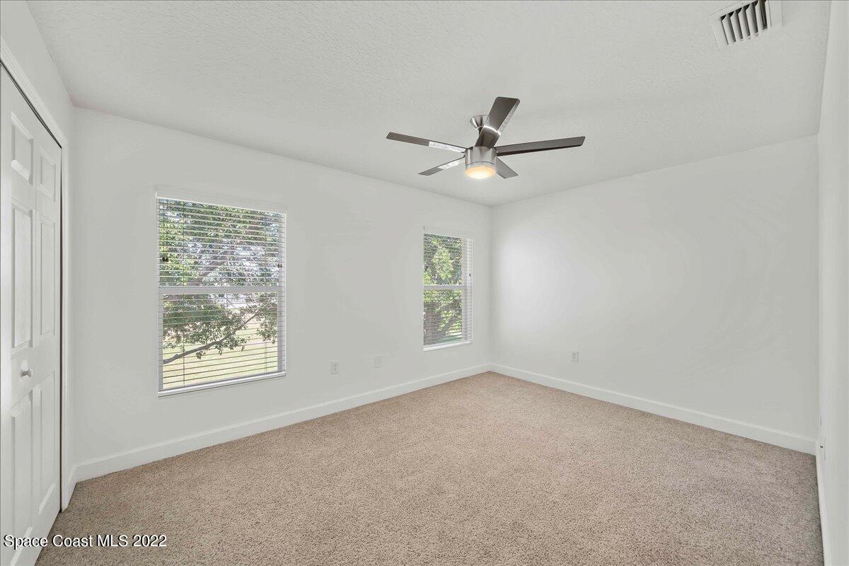 3126 Arden Circle Melbourne, FL 32934 - Photo 20 of 31 an empty room with a window and a ceiling fan
