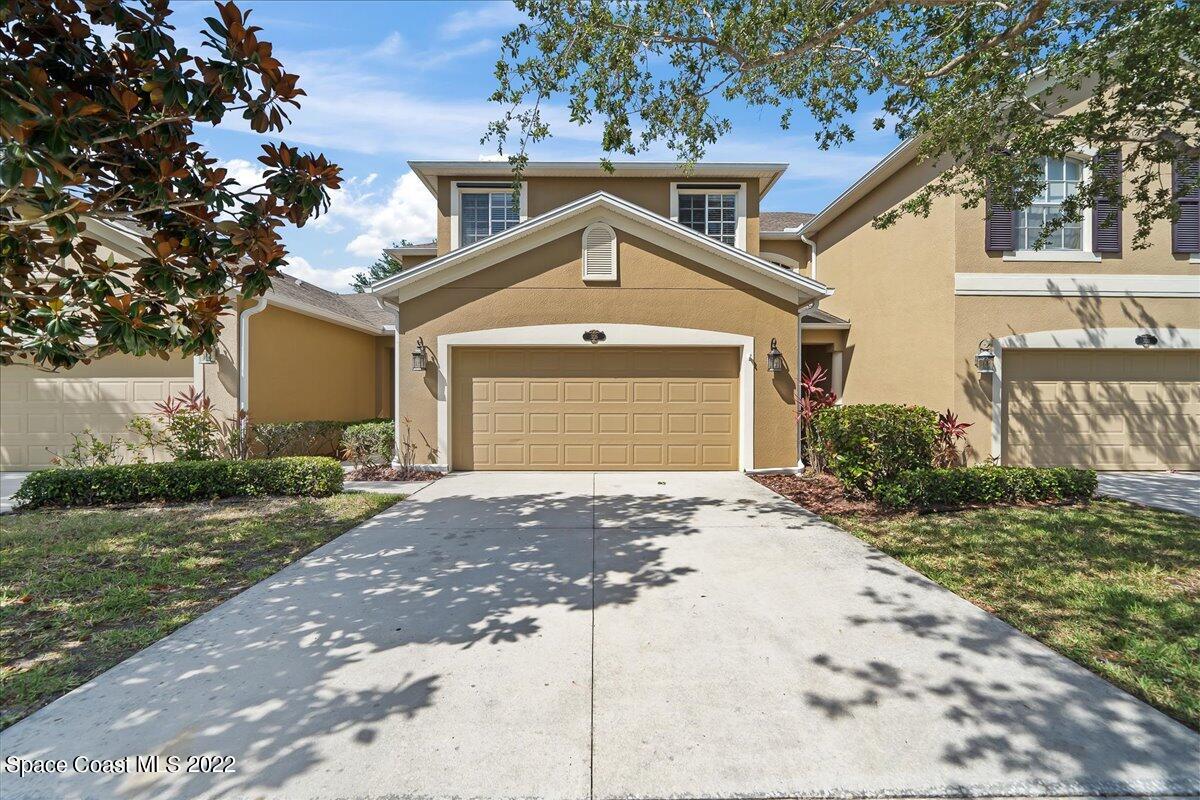 3126 Arden Circle Melbourne, FL 32934 - Photo 2 of 31 a front view of a house with a yard and garage
