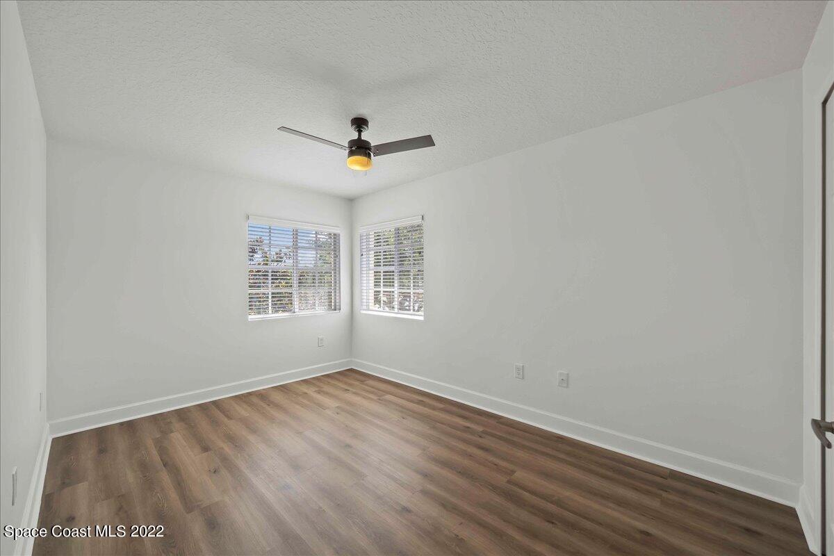 3126 Arden Circle Melbourne, FL 32934 - Photo 25 of 31 a view of a big room with wooden floor and windows