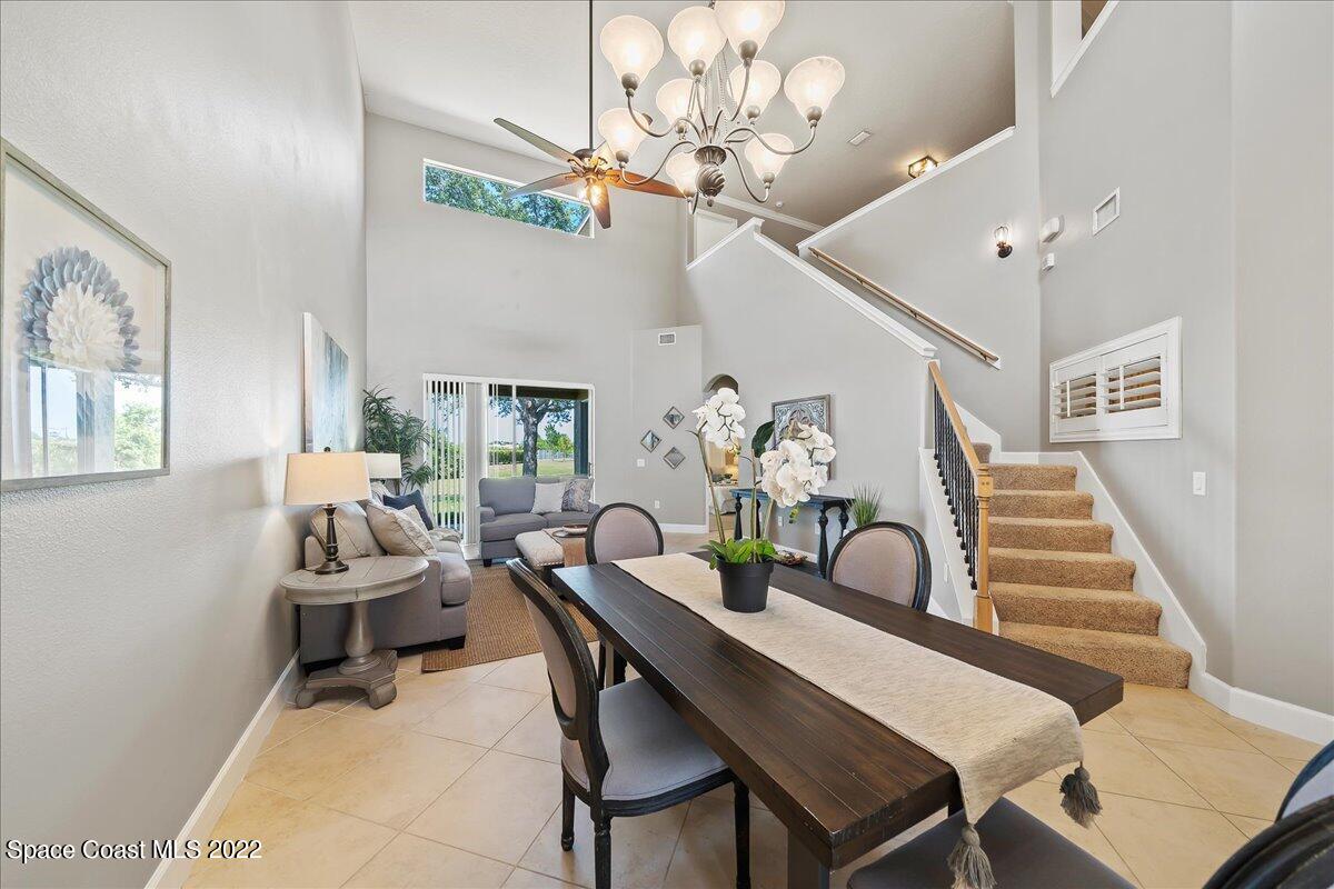 3126 Arden Circle Melbourne, FL 32934 - Photo 7 of 31 a dining room with furniture and chandelier