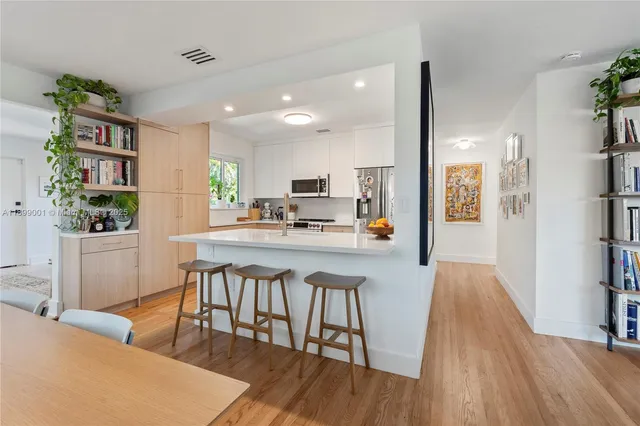 a kitchen with white cabinets and stainless steel appliances