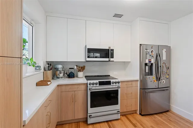 a kitchen with a refrigerator stove and microwave