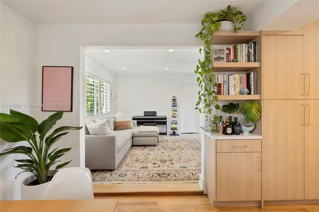 a living room with furniture and a potted plant