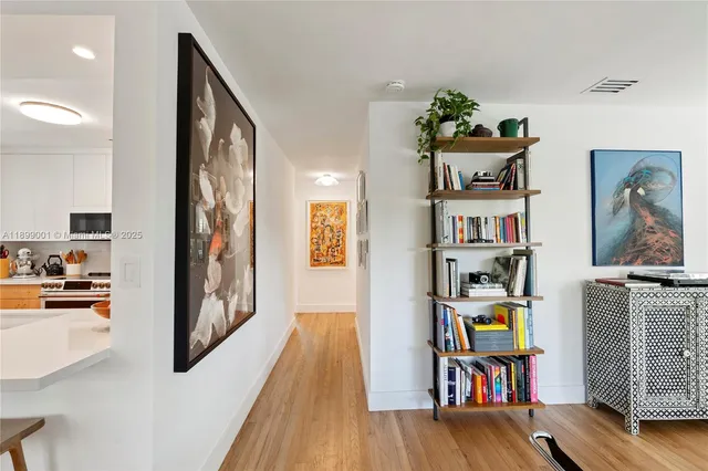 a view of a workspace with furniture and wooden floor