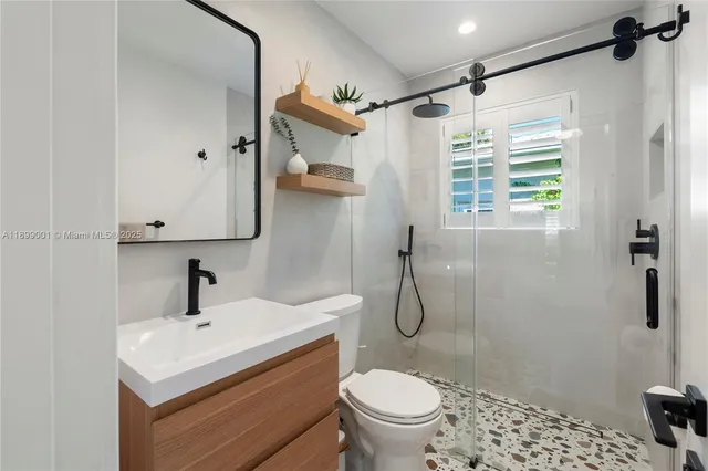 a bathroom with a sink toilet and shower