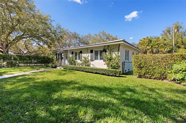 a view of house with yard and green space