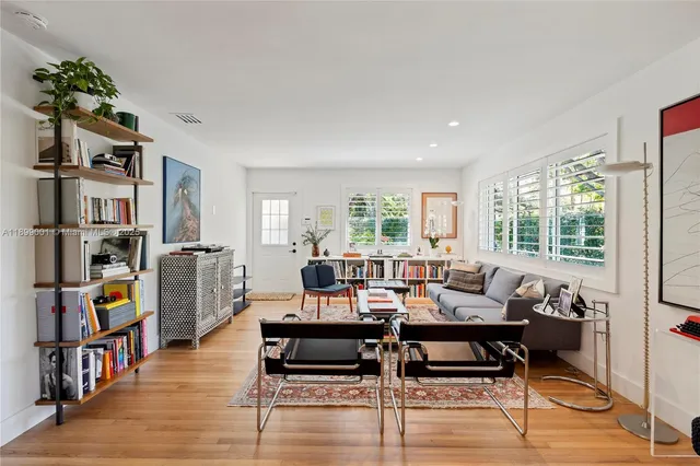 a living room with furniture and a book shelf