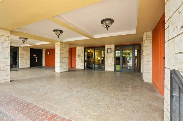 a living room with furniture and floor to ceiling windows
